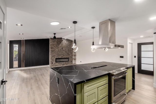 4019 E Surrey Ave, Phoenix, AZ 85032 - kitchen featuring stainless steel range with electric cooktop, a ceiling fan, island exhaust hood, dark countertops, and green cabinetry