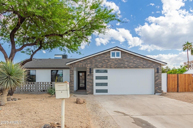 4019 E Surrey Ave, Phoenix, AZ 85032 - ranch-style house with stone siding, driveway, a garage, and fence