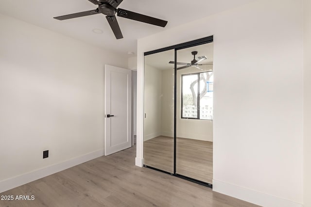 4019 E Surrey Ave, Phoenix, AZ 85032 - unfurnished bedroom with a closet, baseboards, visible vents, ceiling fan, and light wood-type flooring