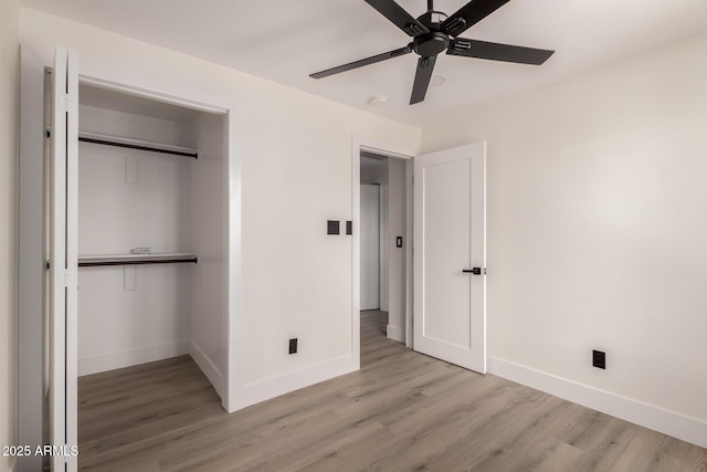 4019 E Surrey Ave, Phoenix, AZ 85032 - unfurnished bedroom featuring wood finished floors, ceiling fan, baseboards, and a closet