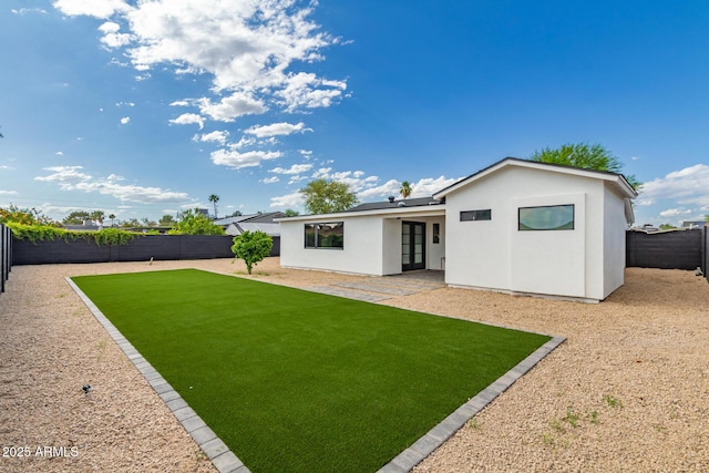 4019 E Surrey Ave, Phoenix, AZ 85032 - back of house with a yard, a fenced backyard, stucco siding, a patio area, and french doors