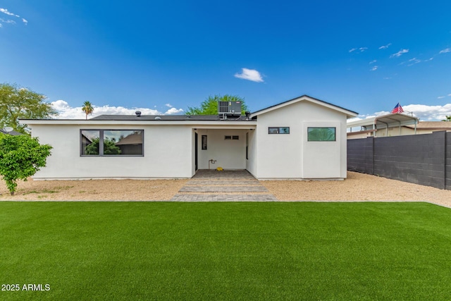 4019 E Surrey Ave, Phoenix, AZ 85032 - back of property featuring a yard, central AC unit, stucco siding, and fence