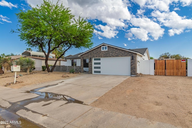 4019 E Surrey Ave, Phoenix, AZ 85032 - ranch-style home featuring an attached garage, fence, a gate, and concrete driveway