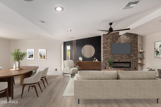 4019 E Surrey Ave, Phoenix, AZ 85032 - living room featuring visible vents, vaulted ceiling, a ceiling fan, and light wood-style flooring