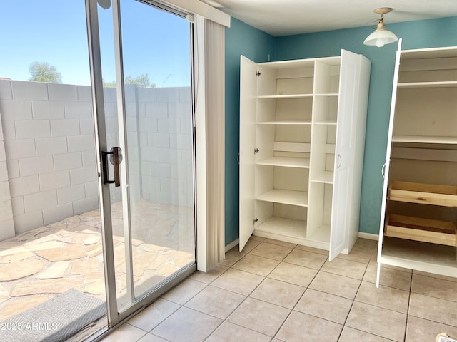 19601 N 7th St Ave Unit 1036, Phoenix, AZ 85024 - bathroom with tile patterned flooring, a stall shower, a spacious closet, and baseboards