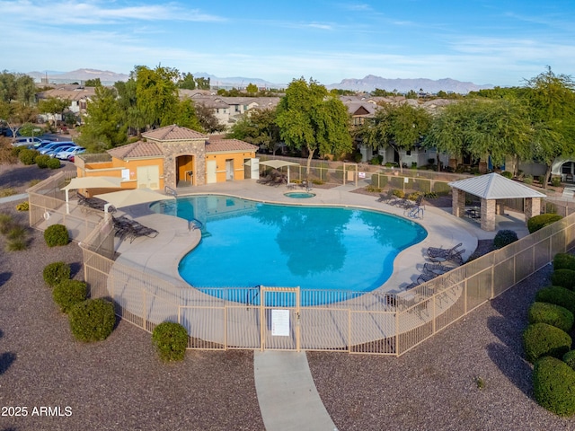 pool with a gazebo, a patio, fence, and a mountain view