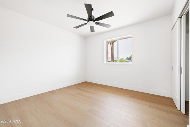 unfurnished bedroom with light wood-style floors, baseboards, a closet, and ceiling fan
