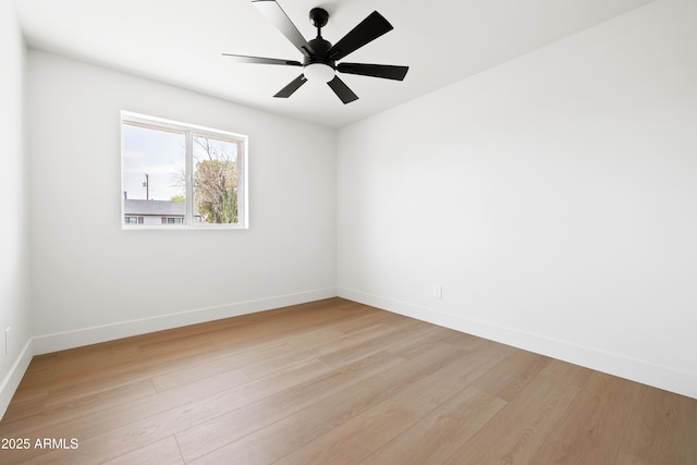 empty room with light wood-style flooring, baseboards, and a ceiling fan