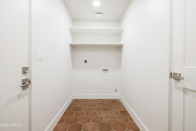 clothes washing area with electric dryer hookup, hookup for a washing machine, dark tile patterned floors, and baseboards