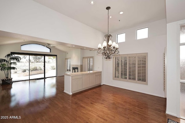 interior space featuring lofted ceiling, a chandelier, and dark hardwood / wood-style flooring