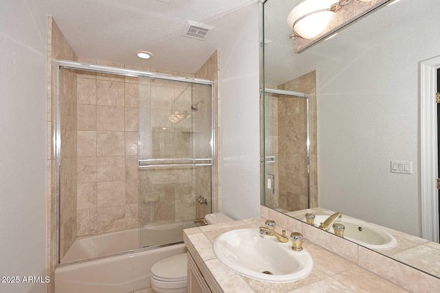 full bathroom featuring vanity, toilet, and combined bath / shower with glass door