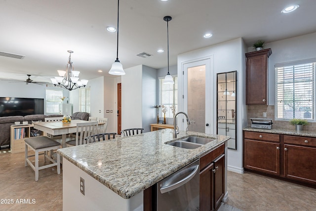 kitchen with dishwasher, visible vents, a sink, and ceiling fan with notable chandelier