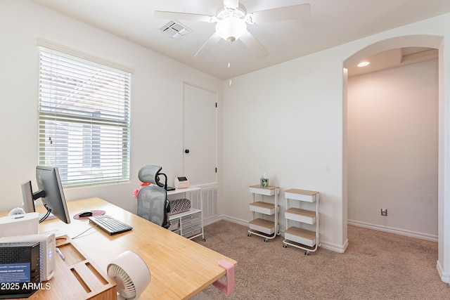 home office with baseboards, a ceiling fan, carpet floors, visible vents, and arched walkways