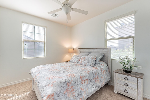 bedroom featuring visible vents, baseboards, a ceiling fan, and light colored carpet