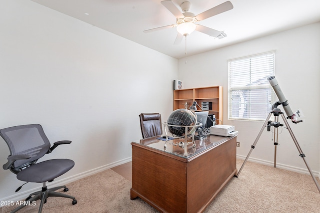 office area featuring visible vents, baseboards, ceiling fan, and light carpet
