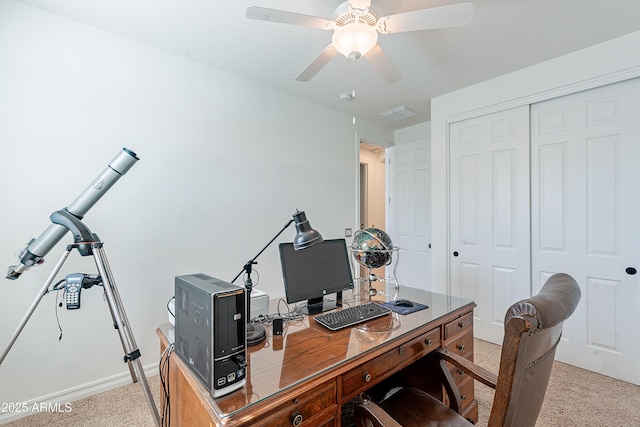 office featuring visible vents, light colored carpet, and ceiling fan