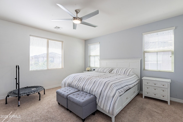 bedroom featuring visible vents, baseboards, ceiling fan, and light colored carpet