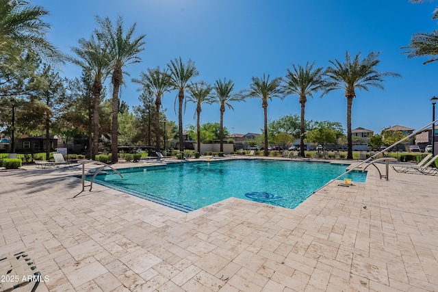 community pool featuring a patio area and fence