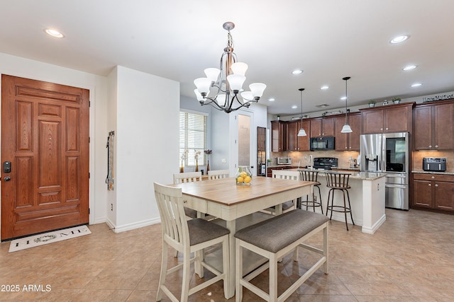 dining area with baseboards, a chandelier, recessed lighting, a toaster, and light tile patterned flooring