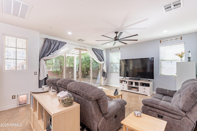 living area featuring visible vents, ceiling fan, and a wealth of natural light