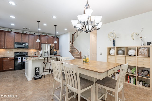 dining space with stairway, an inviting chandelier, visible vents, and recessed lighting