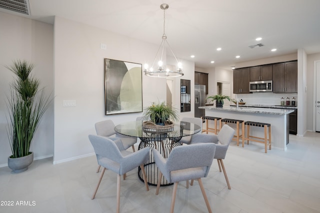 dining room featuring a notable chandelier, recessed lighting, visible vents, and baseboards