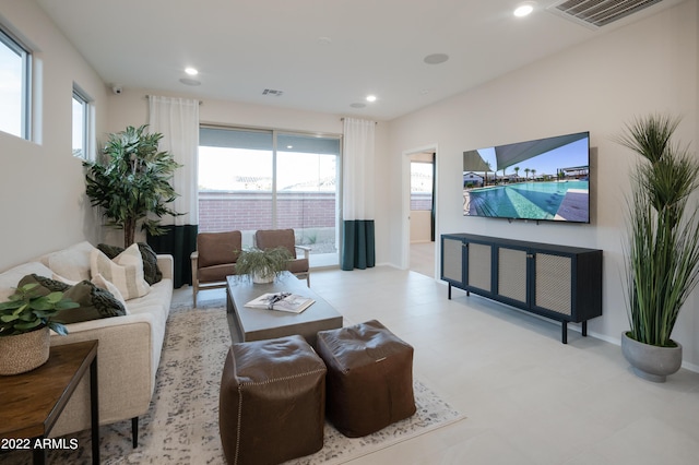 living room with baseboards, visible vents, and recessed lighting