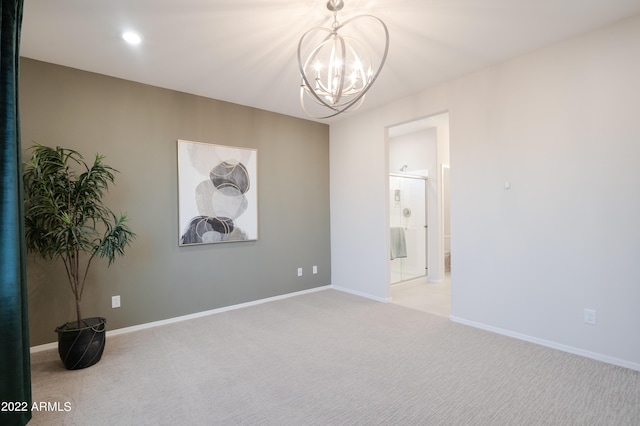 spare room featuring carpet, baseboards, a chandelier, and recessed lighting