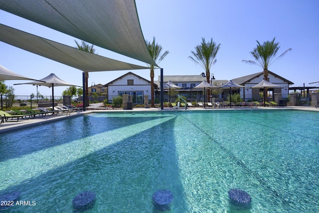 pool featuring fence and a patio