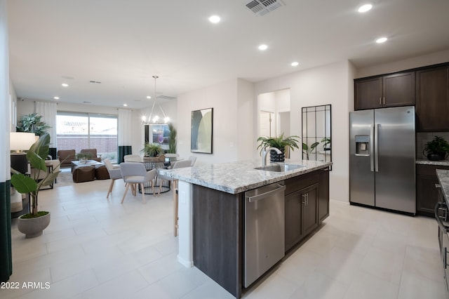 kitchen featuring dark brown cabinetry, visible vents, appliances with stainless steel finishes, a sink, and recessed lighting