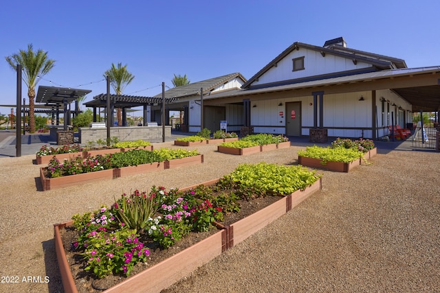 view of front of house featuring a garden and a pergola