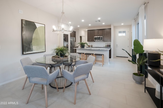 dining room featuring baseboards, visible vents, a notable chandelier, and recessed lighting