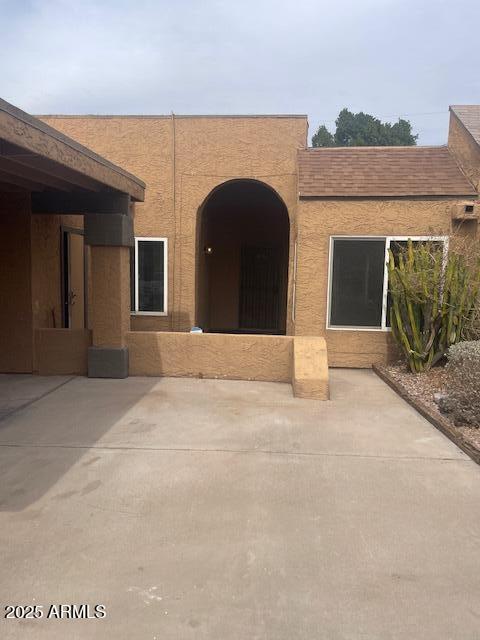 view of front facade featuring a patio area and stucco siding