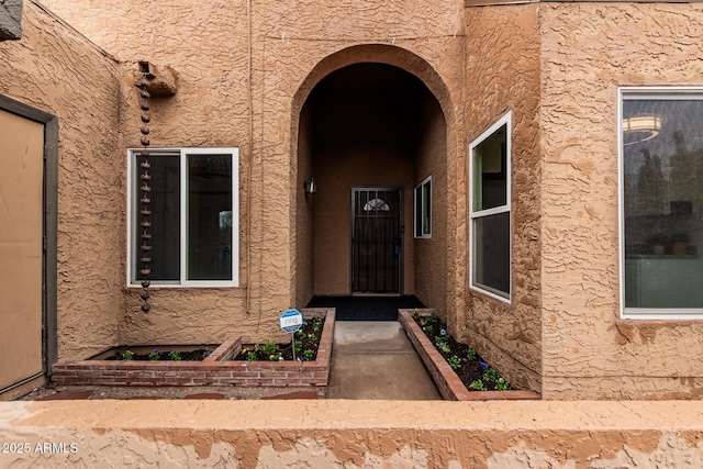 property entrance with stucco siding