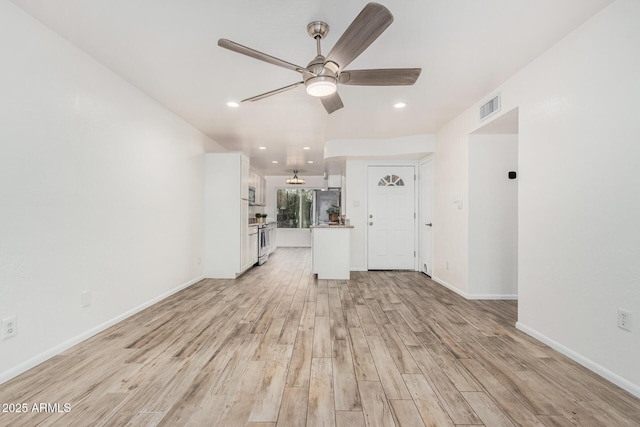 unfurnished living room with recessed lighting, visible vents, baseboards, a ceiling fan, and light wood finished floors