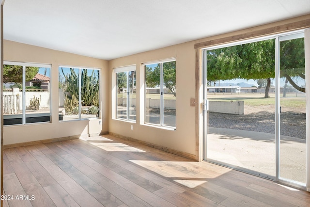 unfurnished sunroom with vaulted ceiling and a wealth of natural light