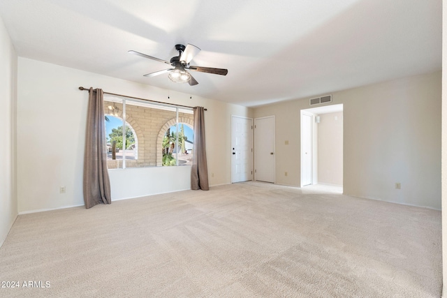 unfurnished room featuring light colored carpet and ceiling fan