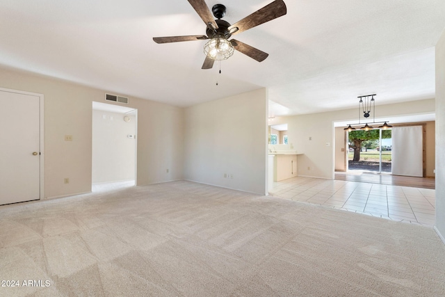 unfurnished living room with light carpet and ceiling fan