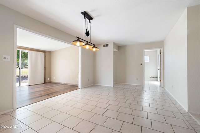 spare room featuring light hardwood / wood-style flooring