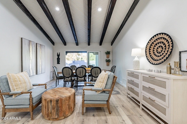 sitting room with light wood-type flooring, vaulted ceiling with beams, and wooden ceiling