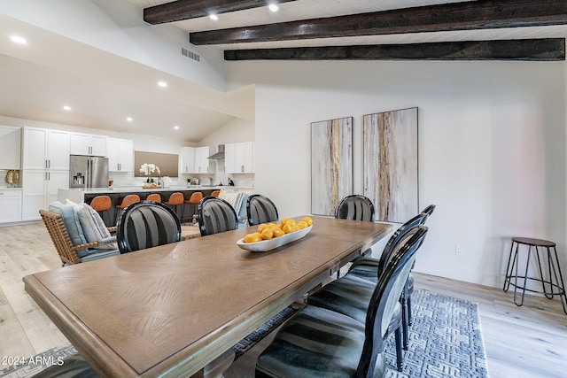 dining space with lofted ceiling with beams, light hardwood / wood-style floors, and wooden ceiling