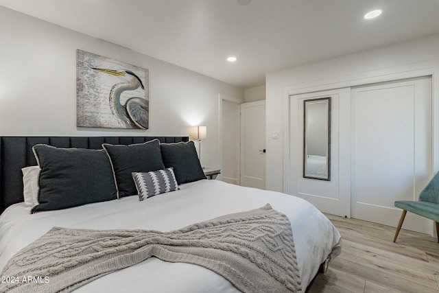 bedroom featuring light hardwood / wood-style flooring and a closet