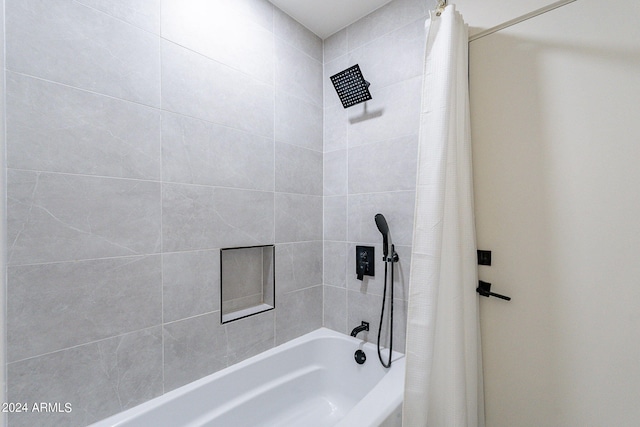 bathroom with shower / bath combination with curtain