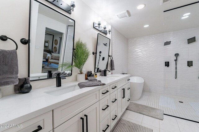 bathroom featuring tile patterned flooring, vanity, and shower with separate bathtub