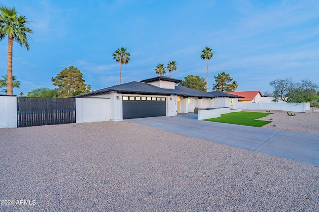 view of front of property featuring a front lawn and a garage