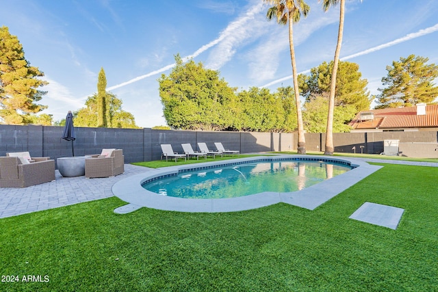 view of pool with outdoor lounge area, a patio area, and a lawn