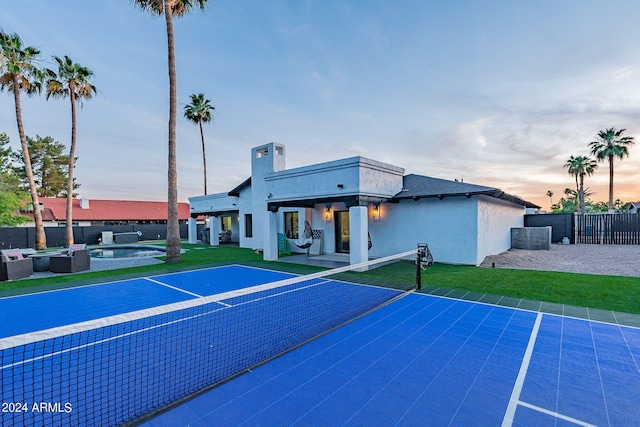 exterior space with outdoor lounge area, a fenced in pool, and basketball hoop