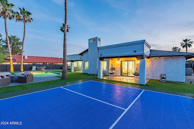 view of sport court with a yard and a fenced in pool