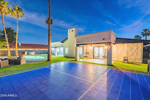 view of sport court with a yard and a fenced in pool