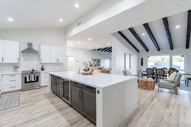 kitchen featuring white cabinets, decorative backsplash, and stainless steel range with electric stovetop